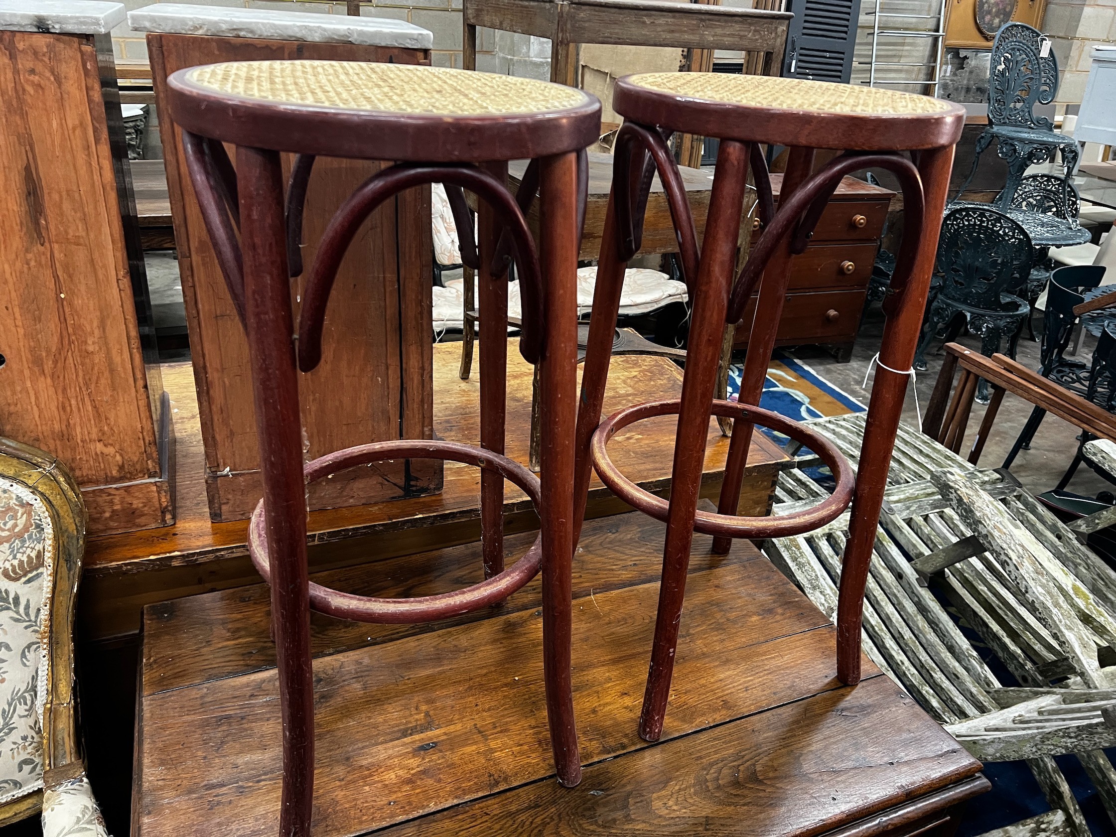 A pair of caned bentwood bar stools, height 76cm